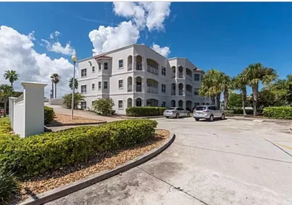 a view of a building with a yard