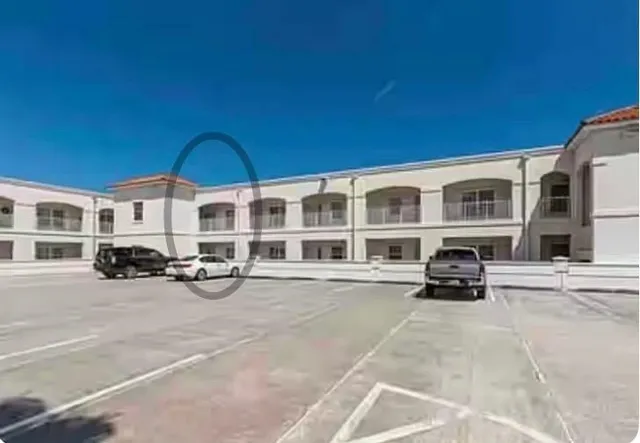 a view of a car park in front of a building