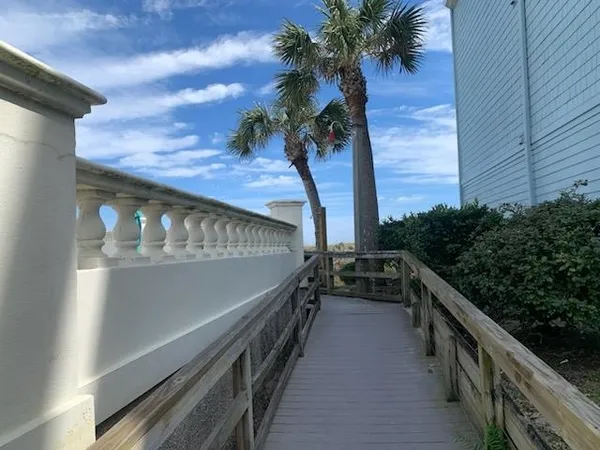 a view of balcony with wooden floor and fence