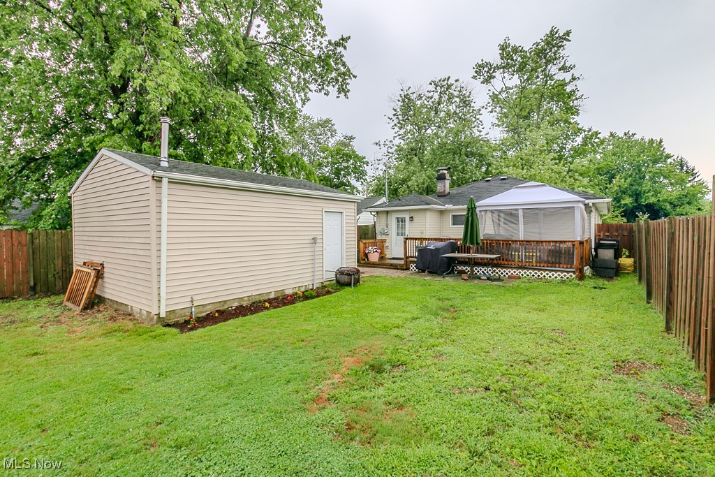 4973 Orchard Road Mentor, OH 44060 - Photo 29 of 30 Rear view of house with a gazebo, a fenced backyard, an outbuilding, and a deck