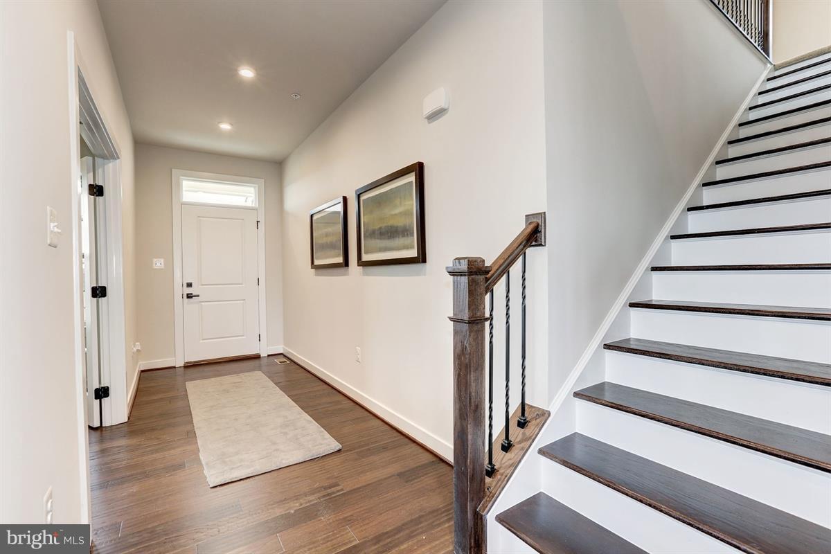 1281 Upper Patuxent Ridge Road Odenton, MD 21113 - Photo 3 of 24 a view of a hallway with wooden floor and staircase