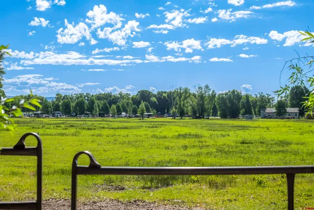 a view of a field with an ocean view