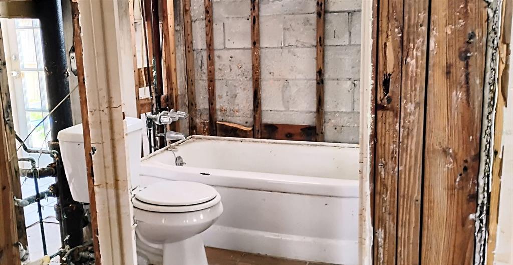 510 Marlyn Way Madeira Beach, FL 33708 - Photo 13 of 32 a bathroom with a toilet and a shower