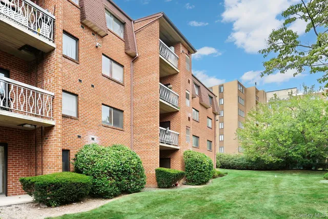 a view of a brick building next to a yard