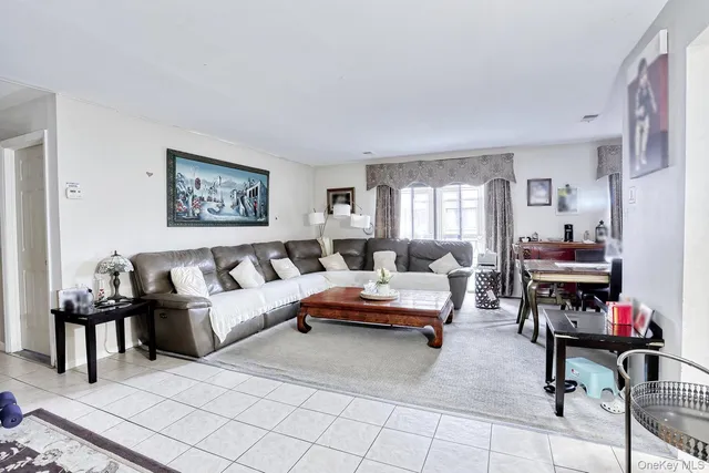 a living room with furniture and a piano
