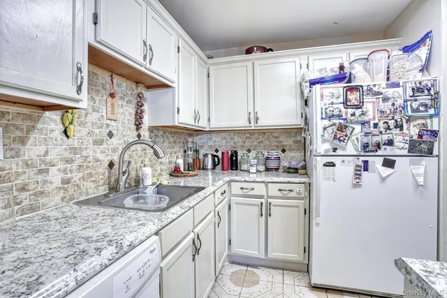 a kitchen with refrigerator and cabinets