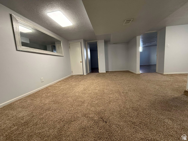 73 Garden Street Helper, UT 84526 - Photo 17 of 36 Finished basement with a textured ceiling and carpet