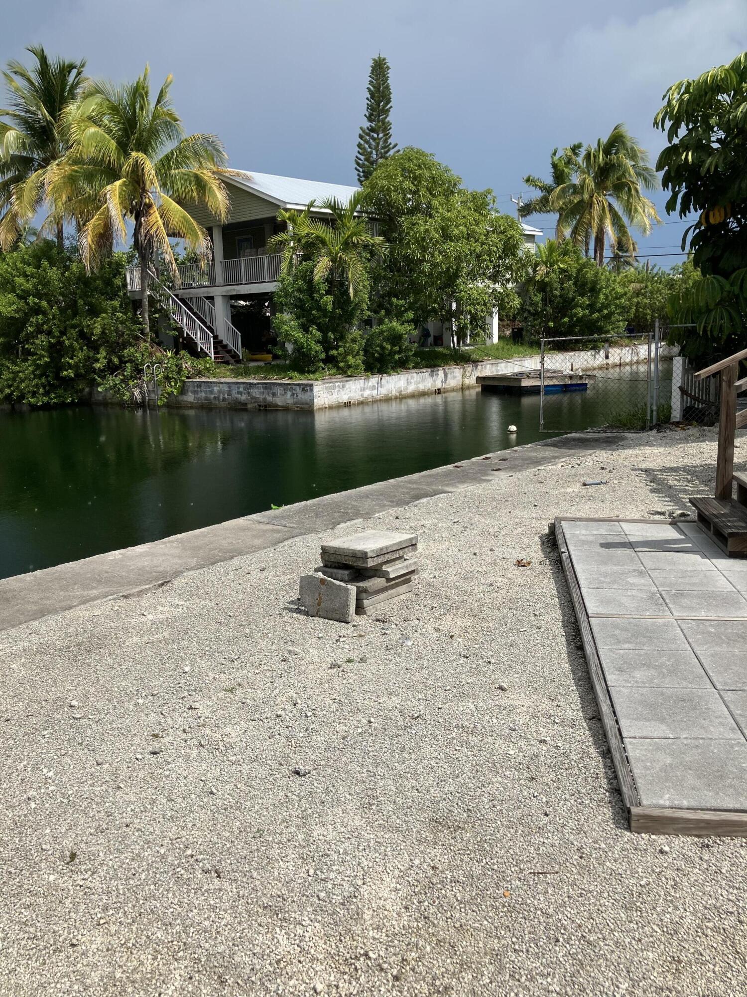 330 Spica Lane Key West, FL 33040 - Photo 4 of 6 a backyard of a house with a yard and outdoor seating