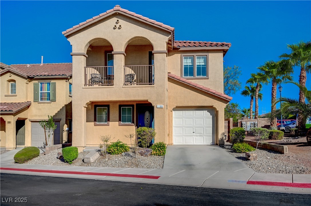 1168 Paradise River Road Henderson, NV 89002 - Photo 1 of 29 Mediterranean / spanish-style house with a tile roof, stucco siding, driveway, a balcony, and a garage