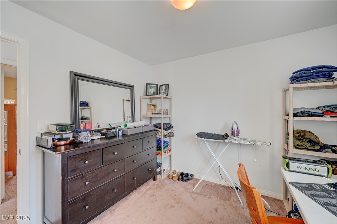 1168 Paradise River Road Henderson, NV 89002 - Photo 16 of 29 Bedroom with light colored carpet and an office area