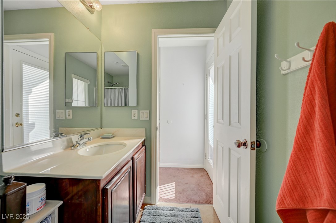1168 Paradise River Road Henderson, NV 89002 - Photo 17 of 29 Bathroom with vanity, light tile patterned floors, and a shower with curtain
