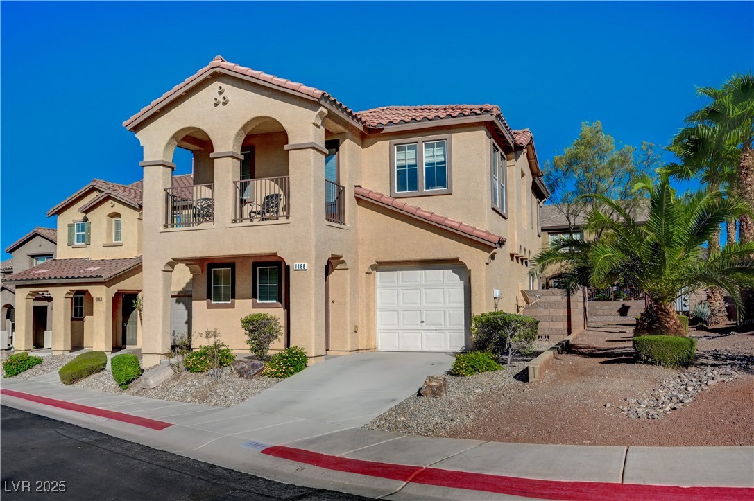 1168 Paradise River Road Henderson, NV 89002 - Photo 2 of 29 Mediterranean / spanish-style home featuring stucco siding, a tile roof, a garage, a balcony, and concrete driveway