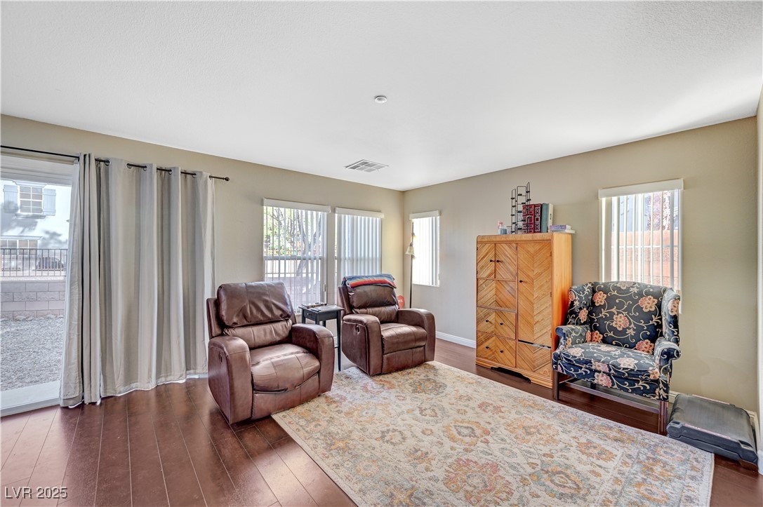 1168 Paradise River Road Henderson, NV 89002 - Photo 8 of 29 Living room featuring dark wood-type flooring and healthy amount of natural light