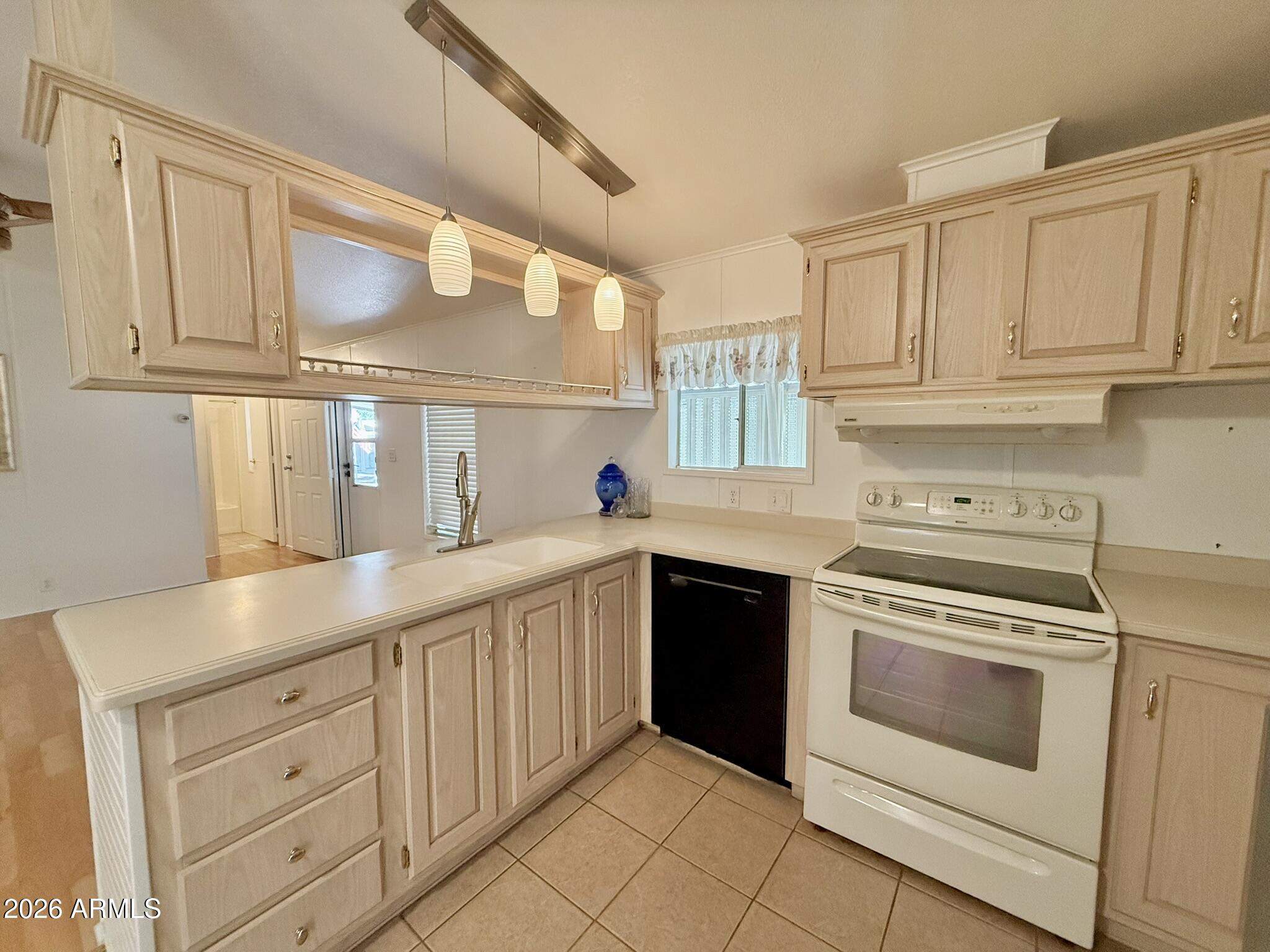 601 North Hayden Road, Unit 40 Scottsdale, AZ 85257 - Photo 11 of 48 a kitchen with white cabinets and white appliances