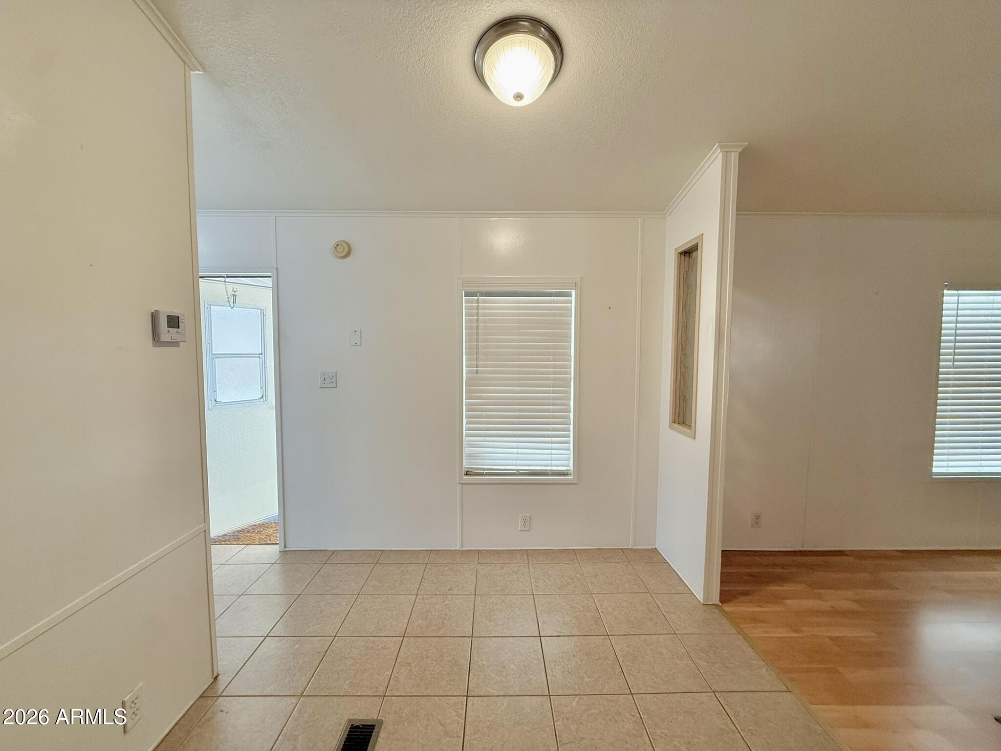 601 North Hayden Road, Unit 40 Scottsdale, AZ 85257 - Photo 13 of 48 a view of an empty room with window and chandelier fan