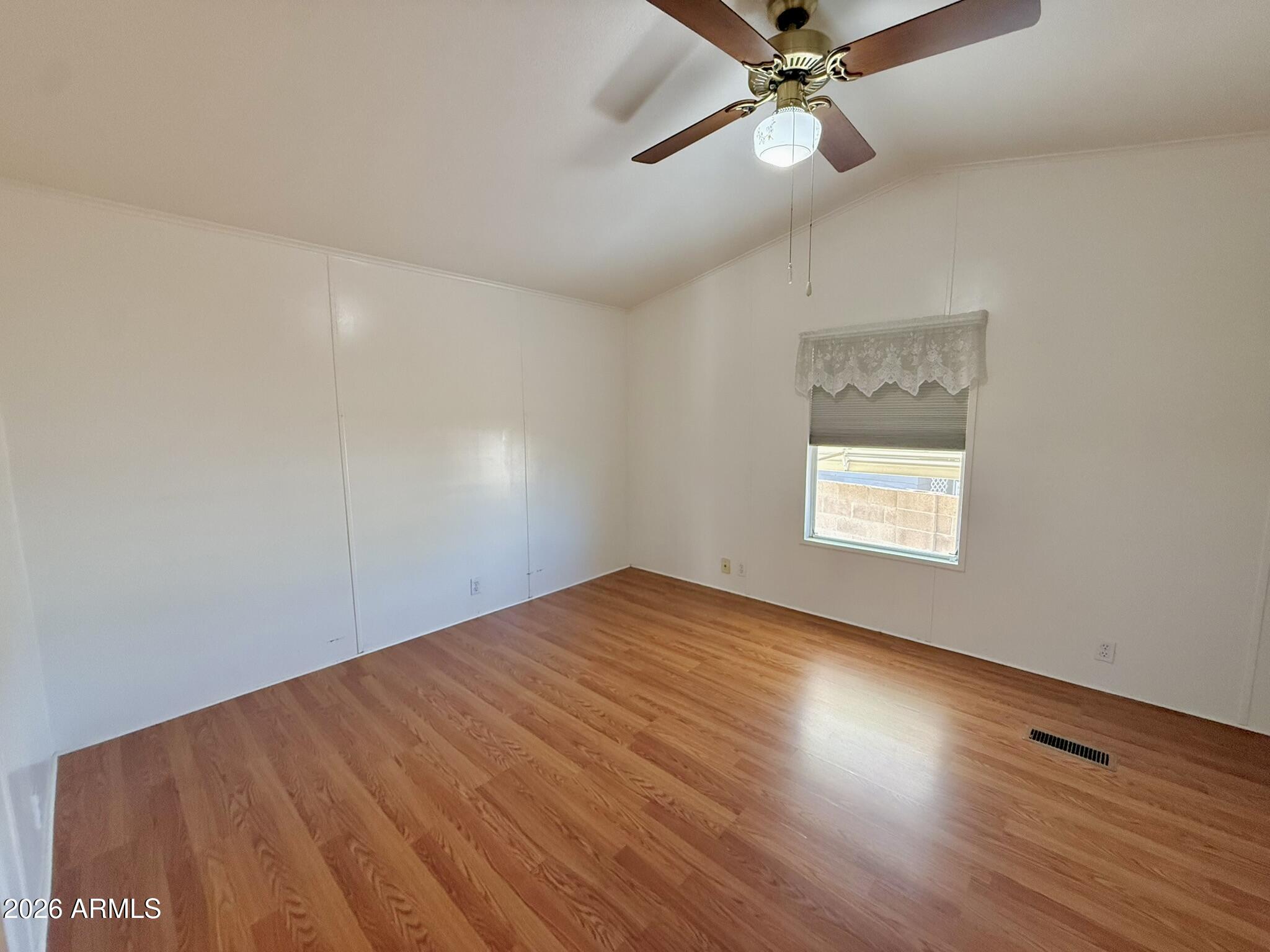 601 North Hayden Road, Unit 40 Scottsdale, AZ 85257 - Photo 18 of 48 an empty room with wooden floor fan and windows