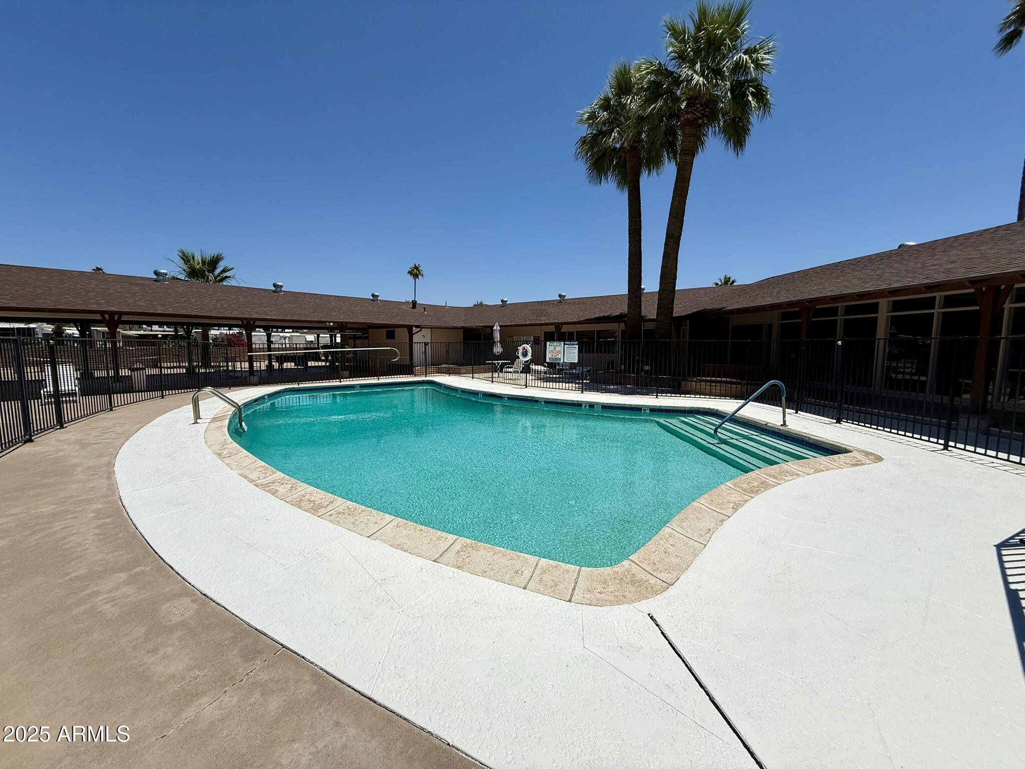 601 North Hayden Road, Unit 40 Scottsdale, AZ 85257 - Photo 38 of 48 a view of a swimming pool with a table and chairs
