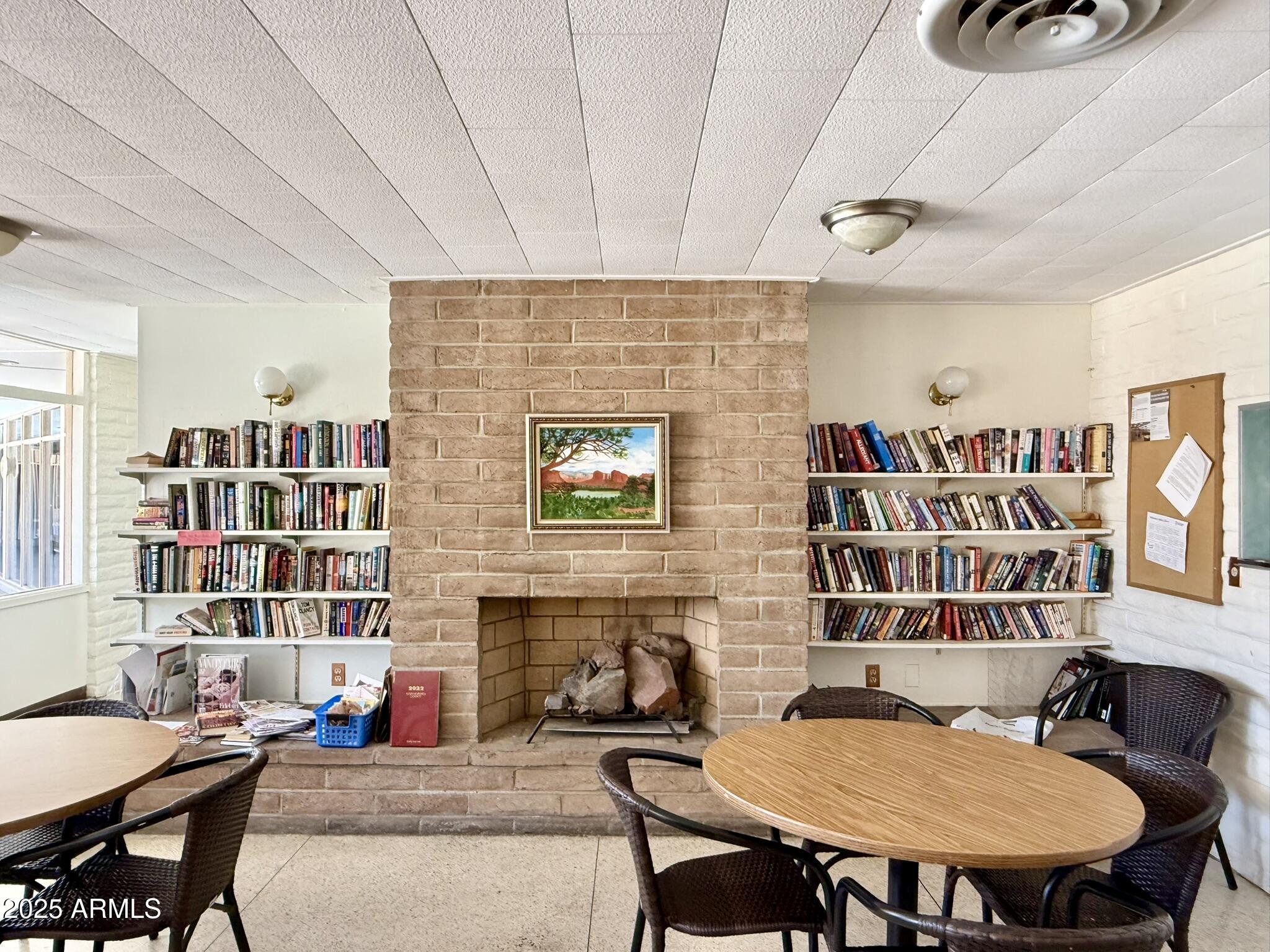 601 North Hayden Road, Unit 40 Scottsdale, AZ 85257 - Photo 45 of 48 a living room with furniture a rug and a bookshelf