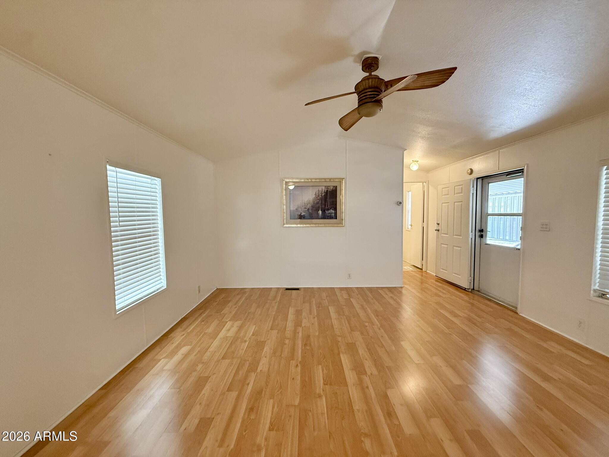 601 North Hayden Road, Unit 40 Scottsdale, AZ 85257 - Photo 7 of 48 a view of empty room with wooden floor and fan