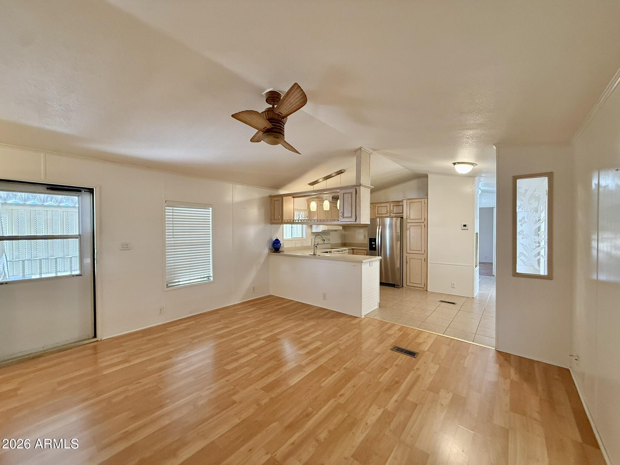 601 North Hayden Road, Unit 40 Scottsdale, AZ 85257 - Photo 8 of 48 a view of a big room with wooden floor and a kitchen