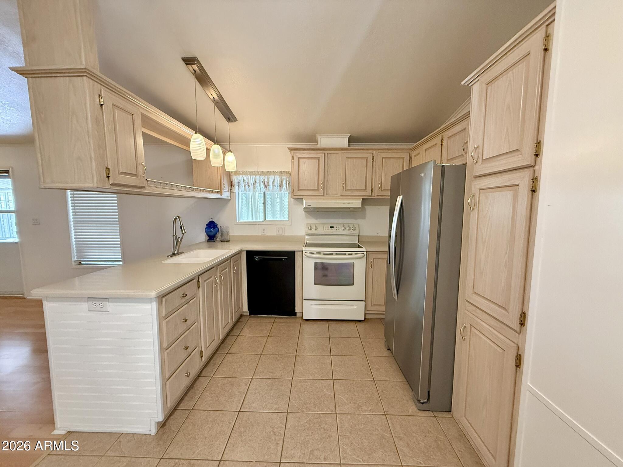 601 North Hayden Road, Unit 40 Scottsdale, AZ 85257 - Photo 9 of 48 a kitchen with stainless steel appliances a refrigerator sink and cabinets