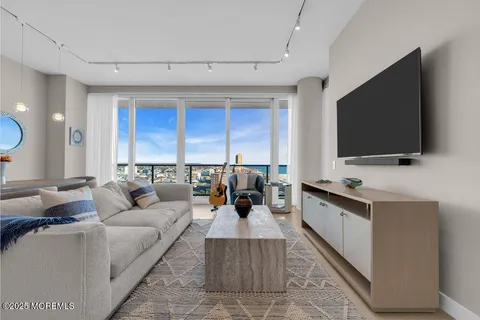 a view of a livingroom with furniture and a flat screen tv