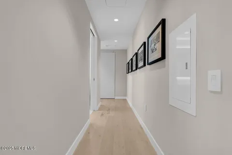 a living room with a bed and glass door