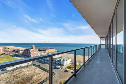 a living room with furniture a large window and a flat screen tv