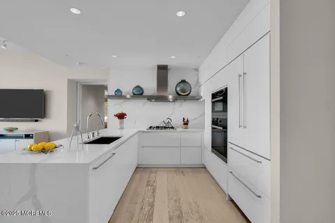 a kitchen with counter top space and living room