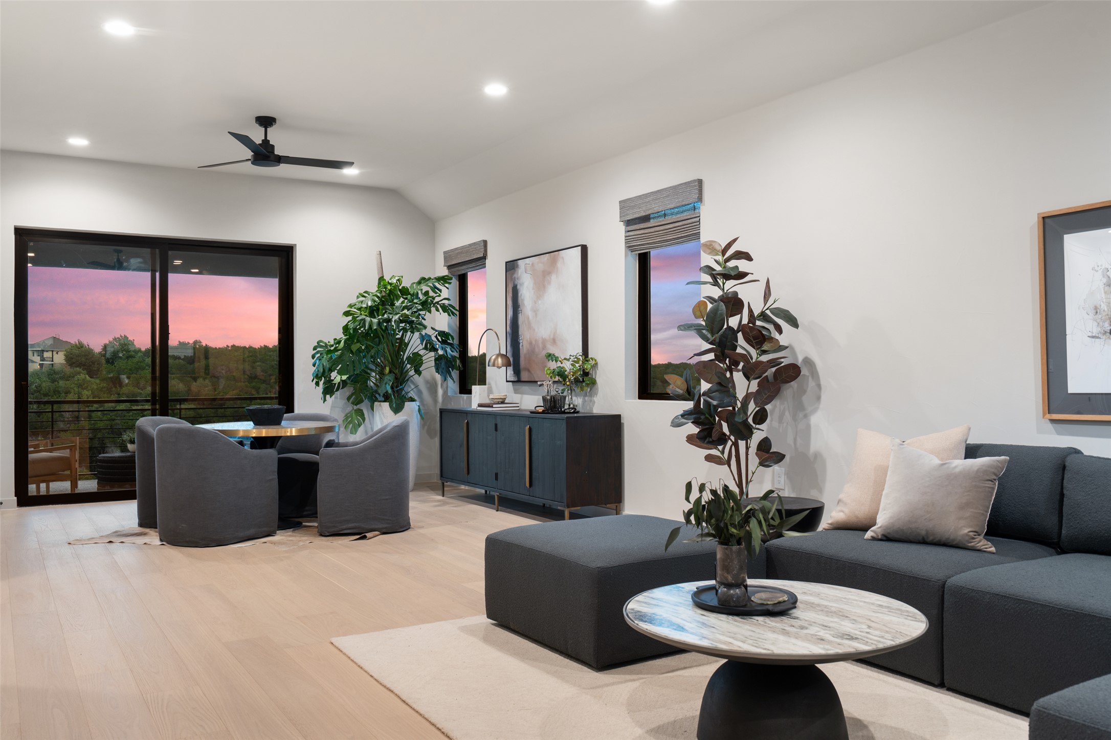 9803 Ribelin Ranch Court, Unit 6 Austin, TX 78750 - Photo 18 of 31 A refined living area boasts light wood flooring and panoramic sunset views through generous windows.