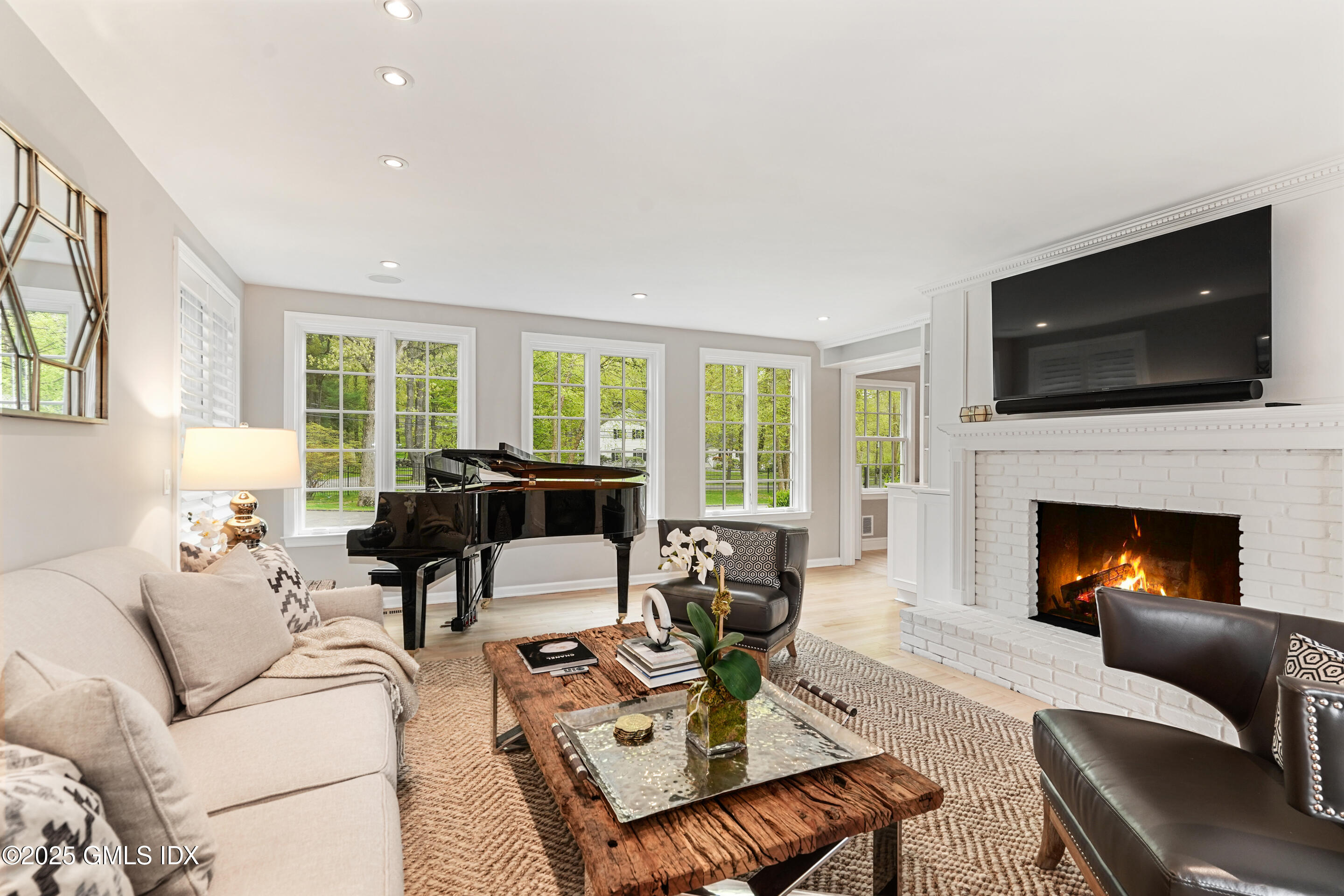 17 Will Merry Lane Greenwich, CT 06831 - Photo 11 of 49 a living room with furniture a flat screen tv and a fireplace