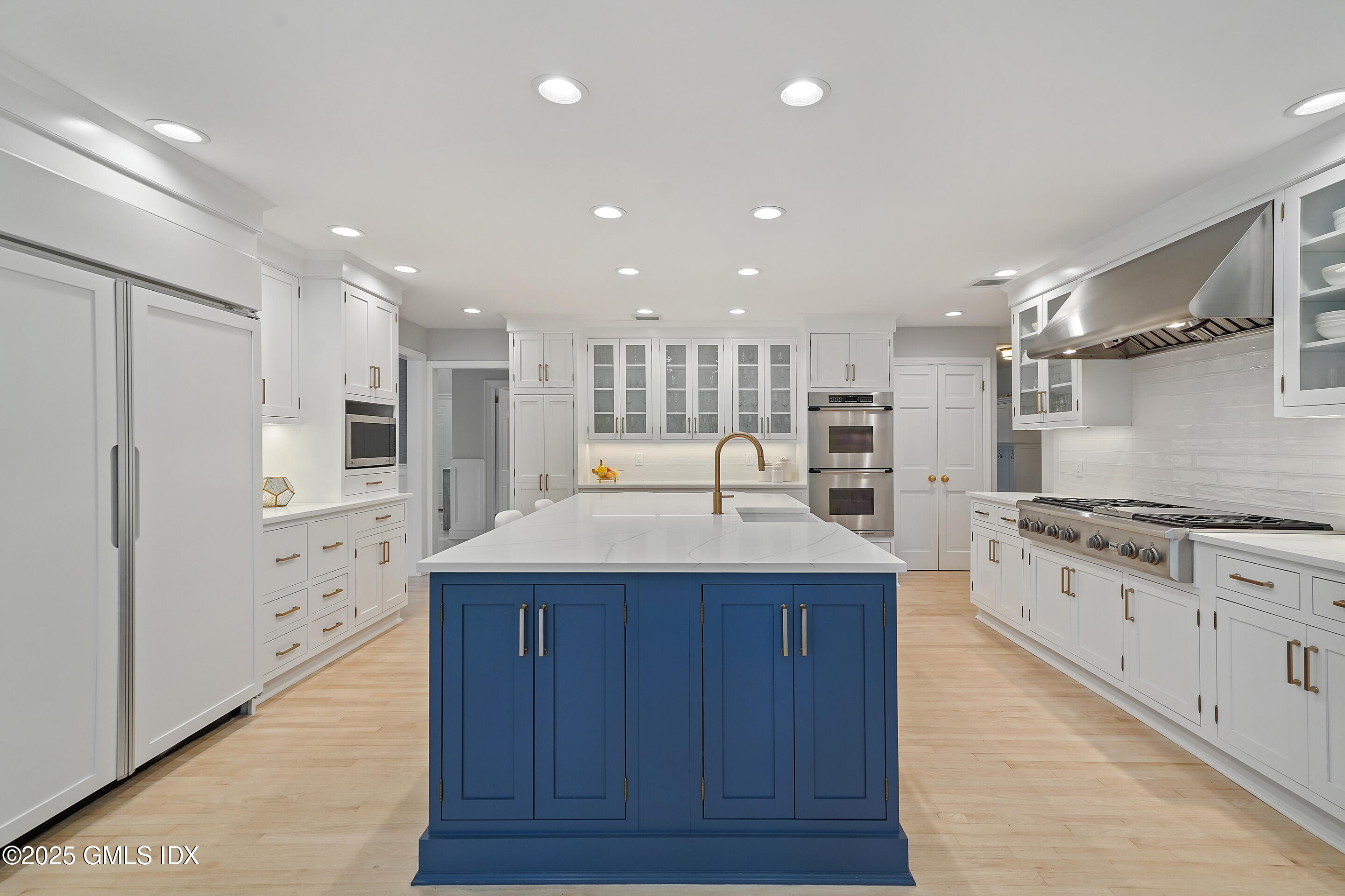 17 Will Merry Lane Greenwich, CT 06831 - Photo 18 of 49 a kitchen with stainless steel appliances kitchen island granite countertop a stove and a refrigerator