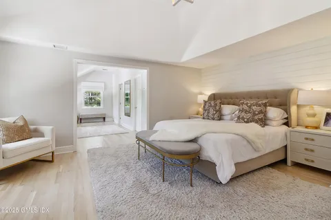 a bathroom with a double vanity sink a mirror and a bathtub