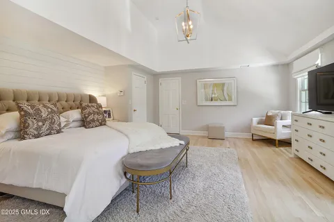 a living room with furniture a lamp and a window