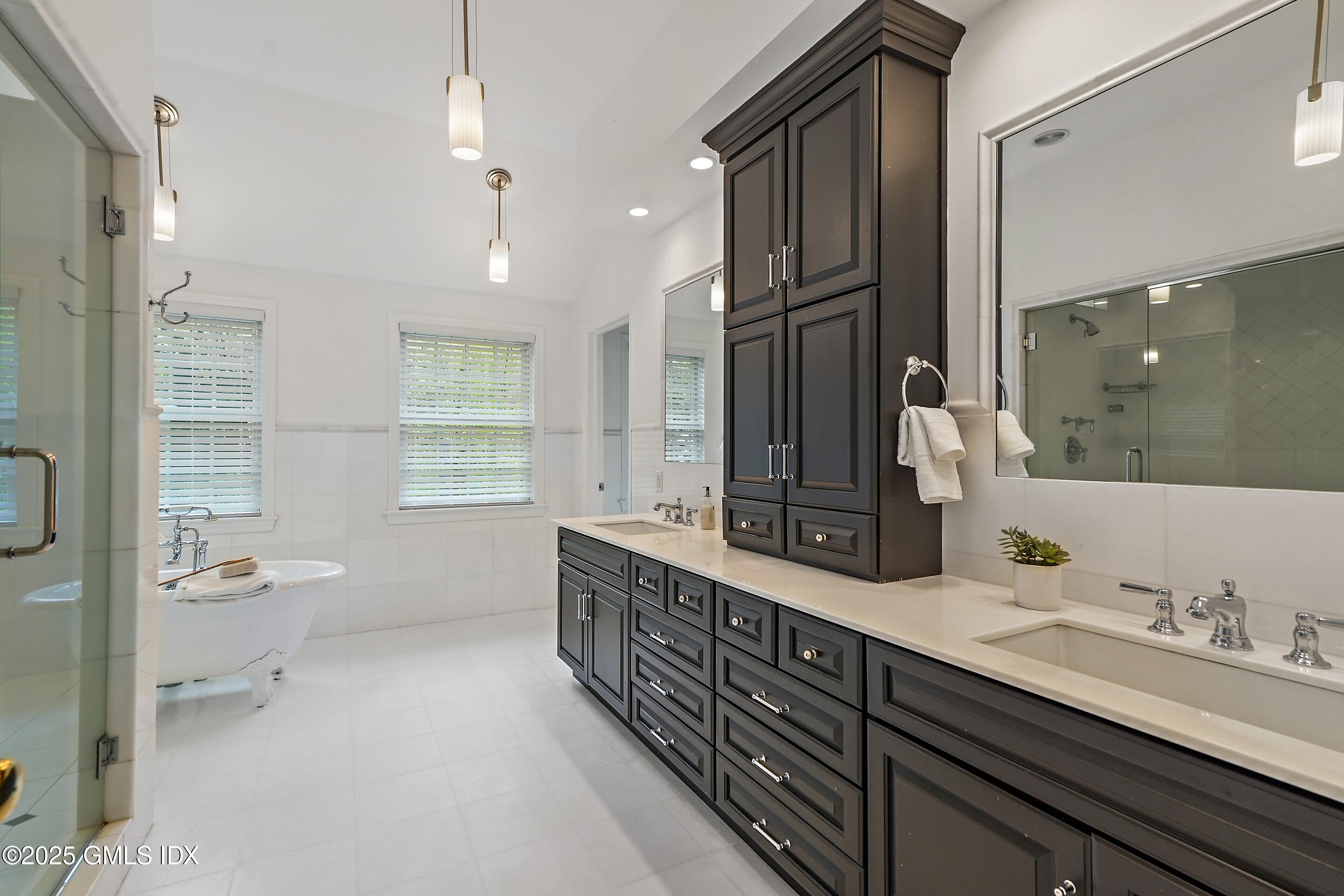 17 Will Merry Lane Greenwich, CT 06831 - Photo 30 of 49 a bathroom with a double vanity sink a mirror and a bathtub
