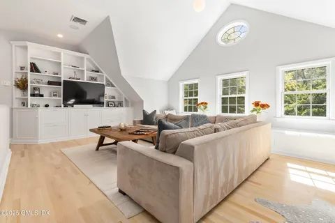 a living room with furniture and view of kitchen
