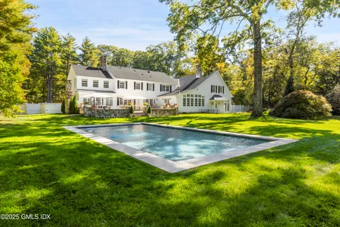 a patio with a table and chairs under an umbrella