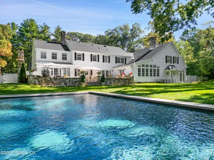 a view of a house with sitting area and garden