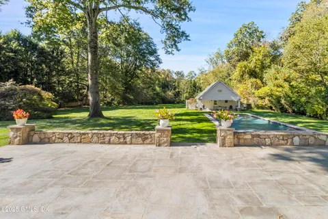 a view of a white house with a yard