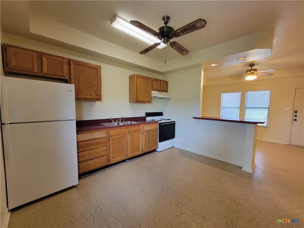 10413 Trimmier Road Killeen, TX 76542 - Photo 4 of 8 Functional kitchen with ample cabinet space, offering seamless flow into the adjacent living area.