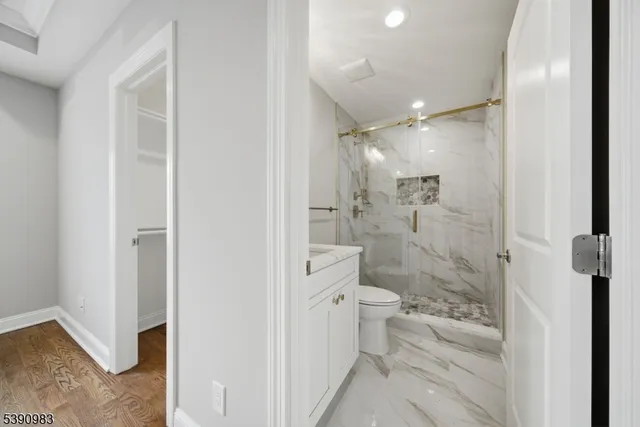 a bathroom with a shower toilet and sink