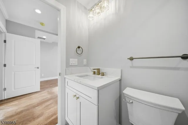 a bathroom with a granite countertop sink a toilet and shower