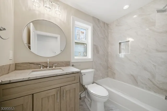 an empty room with wooden floor and entrance