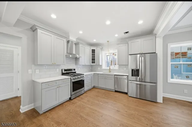 a kitchen with a refrigerator stove top oven and refrigerator