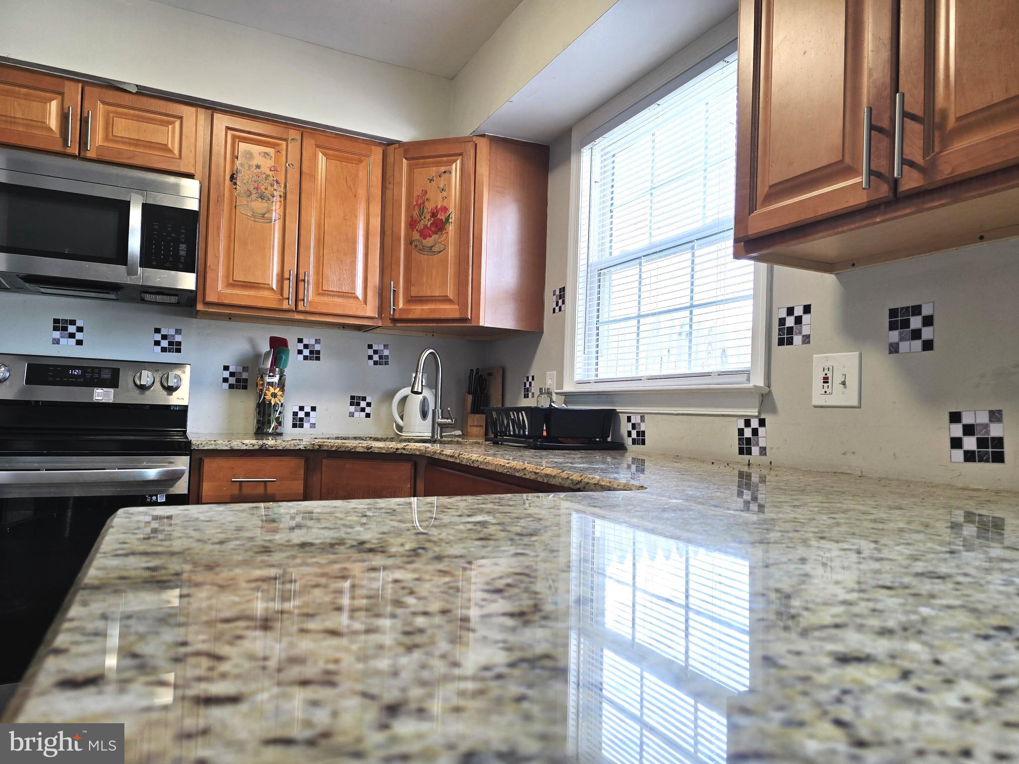 3 Arnold Place Newark, DE 19702 - Photo 4 of 28 a kitchen with granite countertop a sink a window stainless steel appliances and cabinets