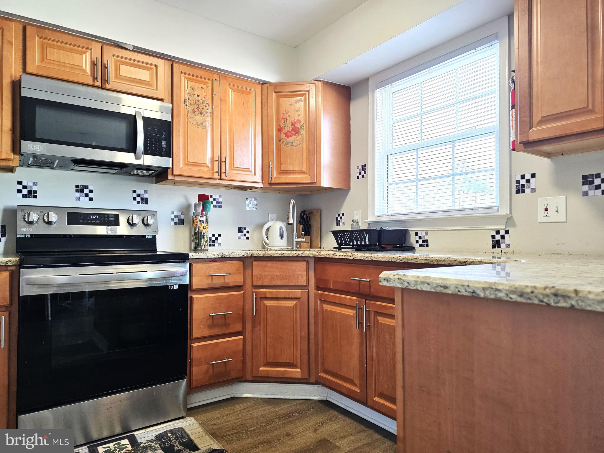 3 Arnold Place Newark, DE 19702 - Photo 6 of 28 a kitchen with stainless steel appliances granite countertop a sink stove and microwave