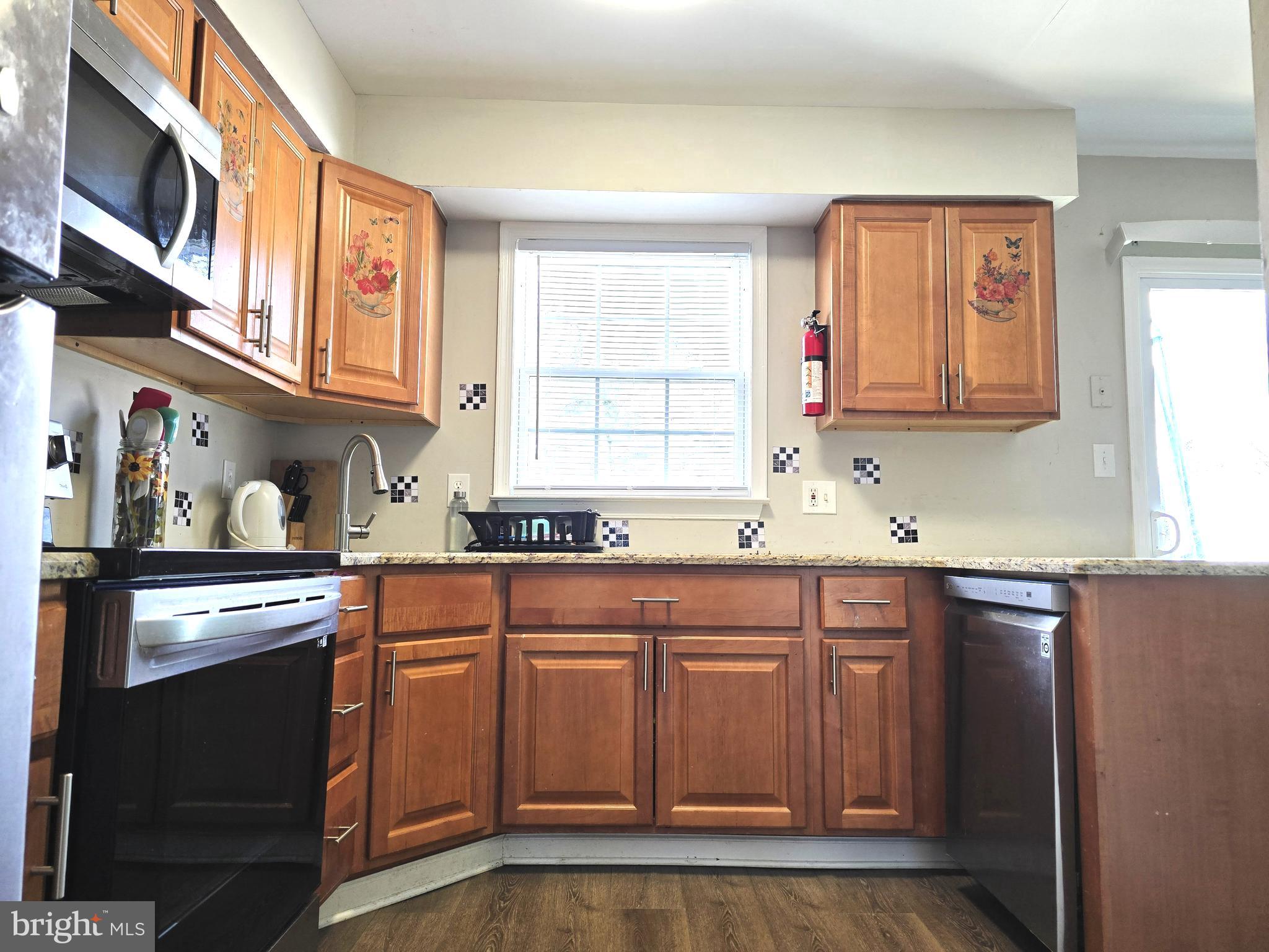 3 Arnold Place Newark, DE 19702 - Photo 7 of 28 a kitchen with stainless steel appliances granite countertop a sink and cabinets