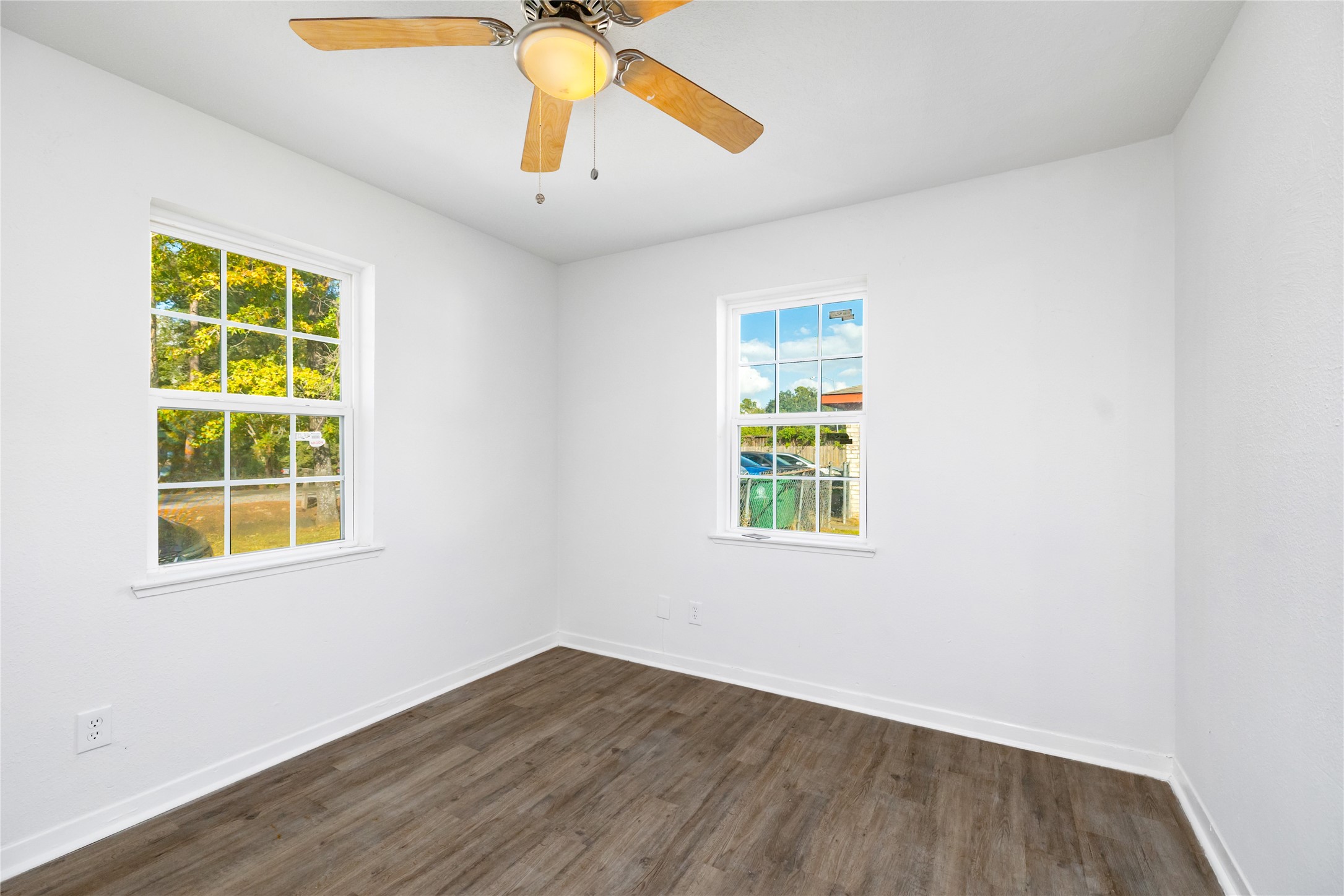 9322 Nyssa Street Houston, TX 77078 - Photo 13 of 34 an empty room with wooden floor and windows