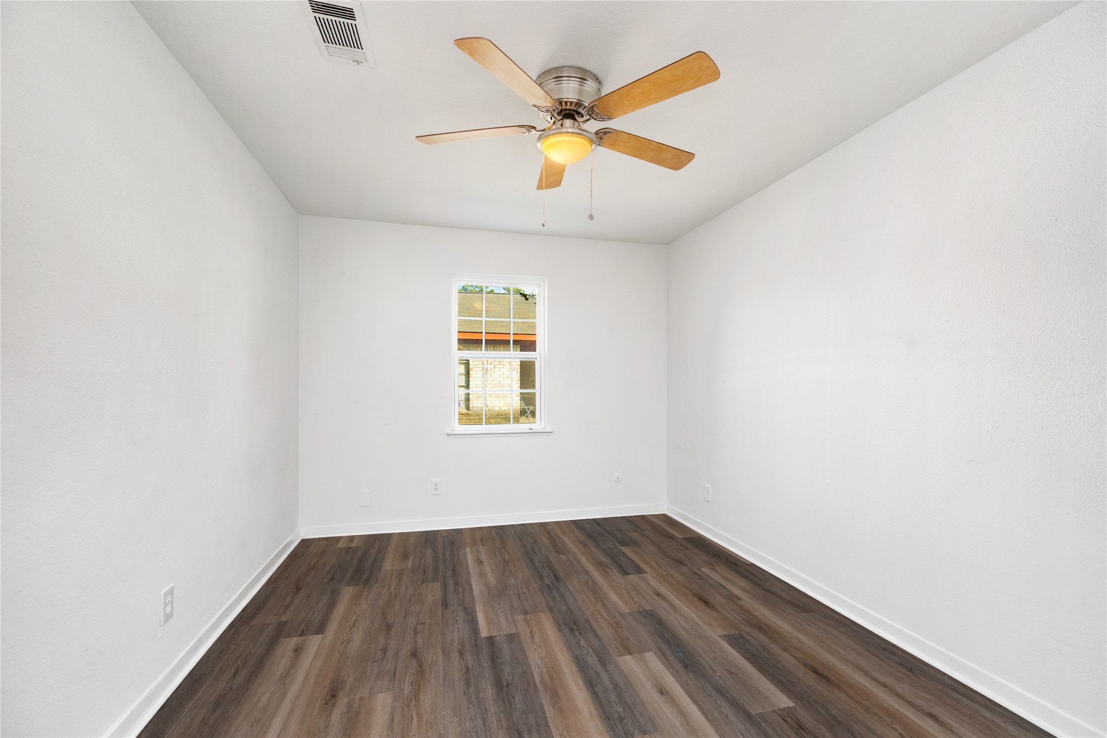 9322 Nyssa Street Houston, TX 77078 - Photo 15 of 34 an empty room with wooden floor and windows