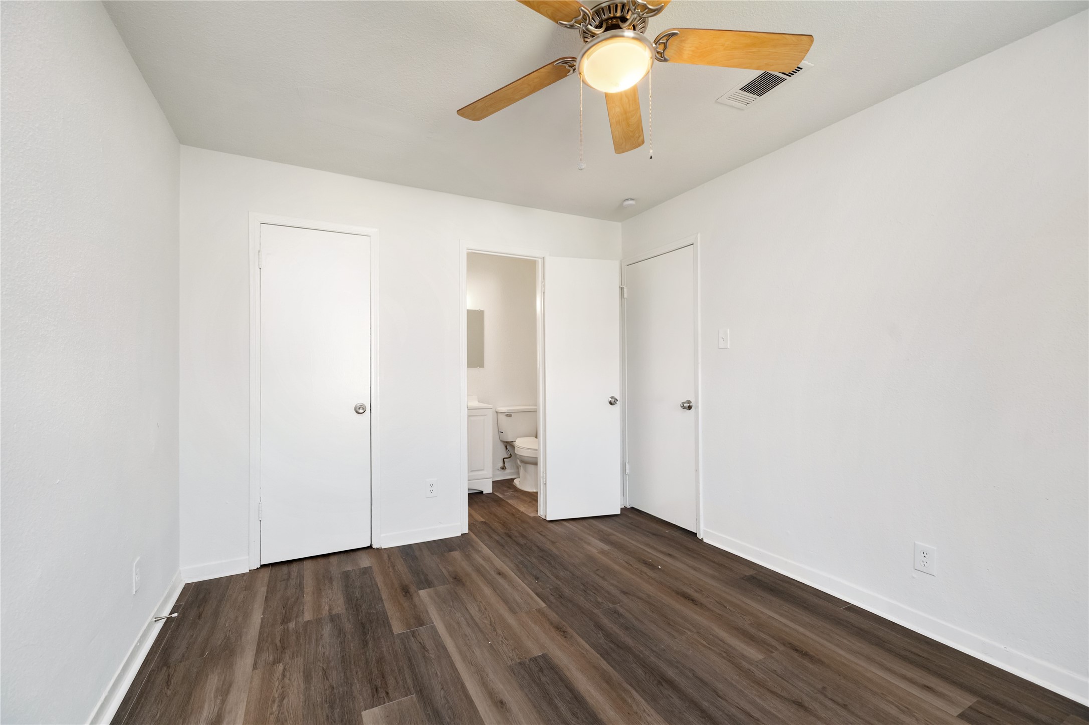 9322 Nyssa Street Houston, TX 77078 - Photo 16 of 34 an empty room with wooden floor and a ceiling fan